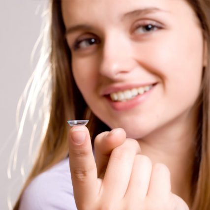 woman holding scleral contact lens
